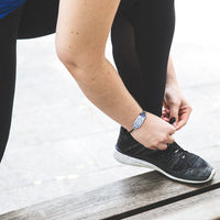 woman runner wearing small medical bracelet